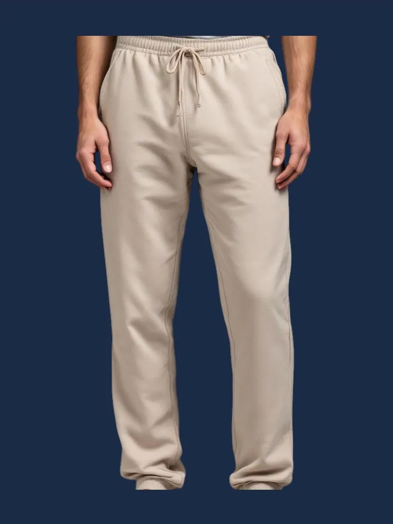 Lounge pant manufacturer Karachi Pakistan showing sand relaxed straight-leg lounge pant with open hem, deep side pockets, and natural drawcord waistband, lightweight French terry, front view